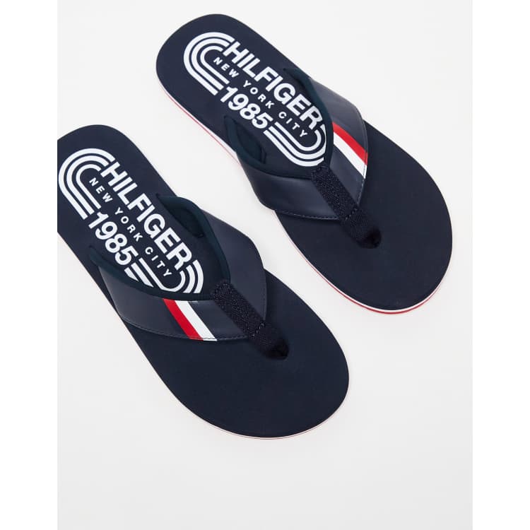 Tommy Hilfiger logo flip flops in navy ASOS