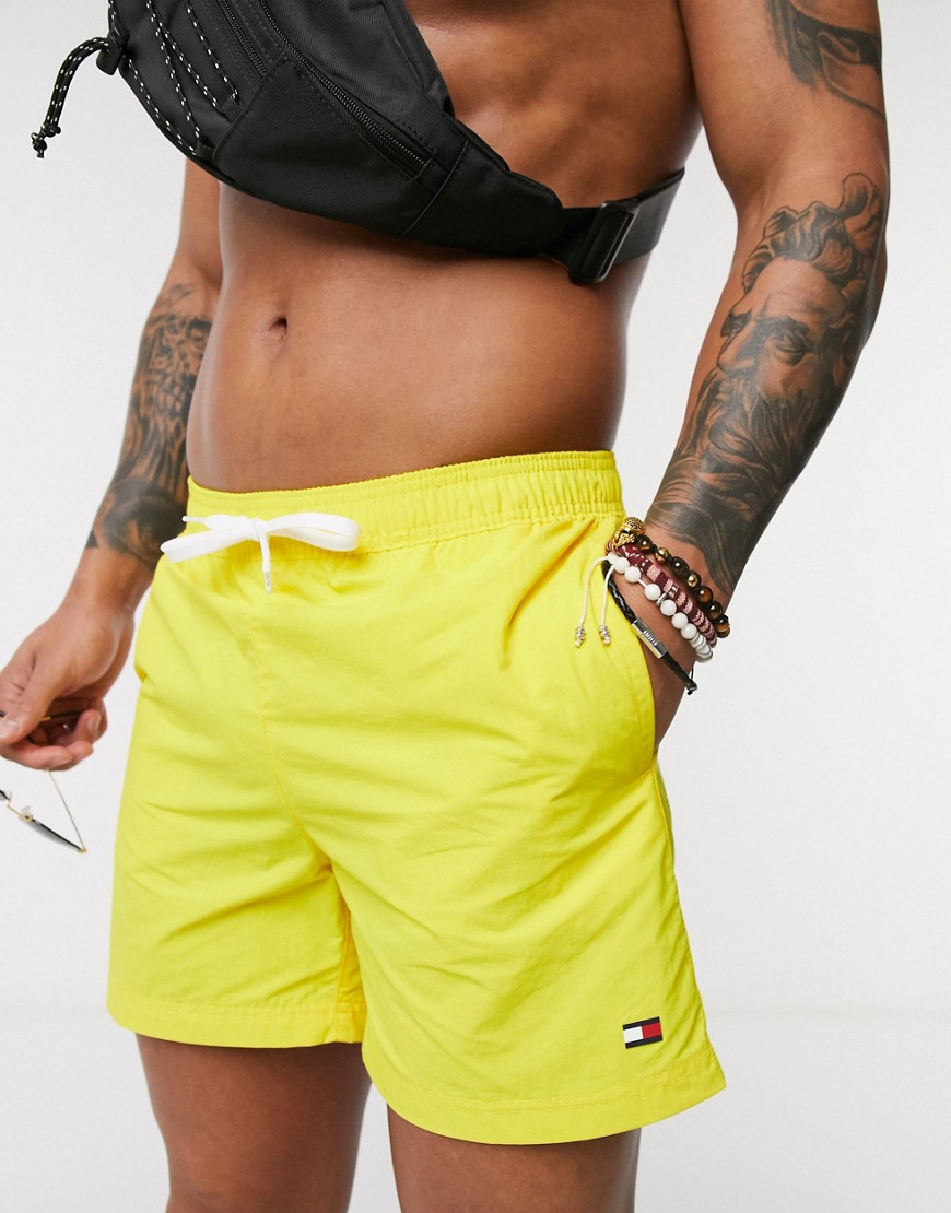 Tommy Hilfiger medium length small logo swim shorts in yellow