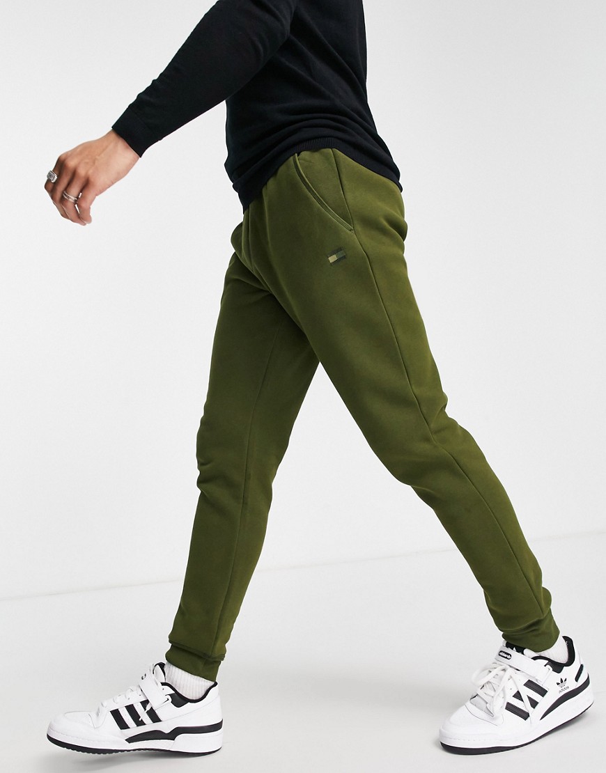 Tommy Hilfiger recycled tonal flag logo cuffed joggers in green