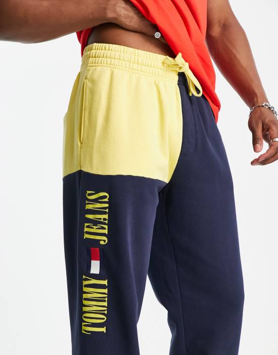 https://images.asos-media.com/products/tommy-jeans-acid-capsule-cotton-blend-color-block-sweatpants-in-blue-yellow-navy/202649165-3?$n_550w$&wid=550&fit=constrain
