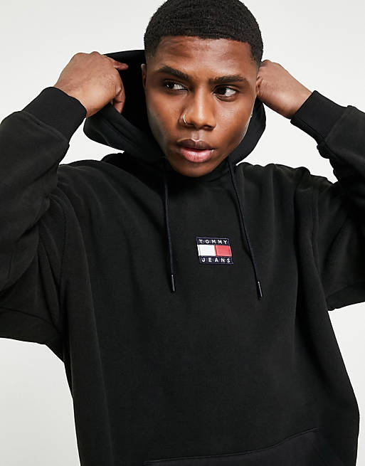 Tommy Jeans badge polar fleece hoodie relaxed fit in black | ASOS