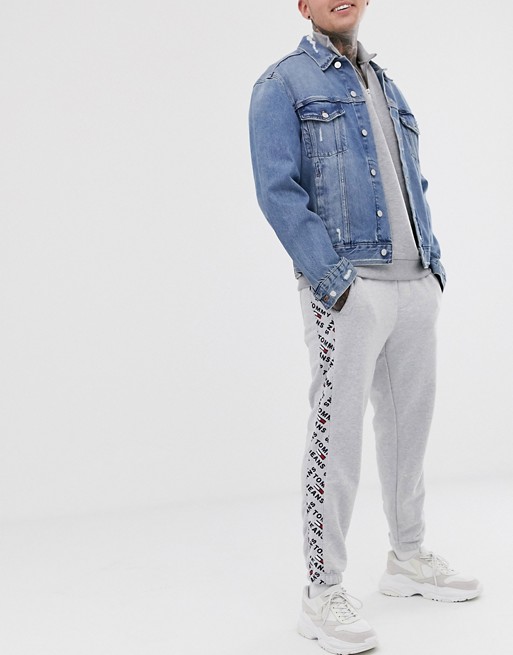 Tommy Jeans corporate joggers in grey with logo print taping
