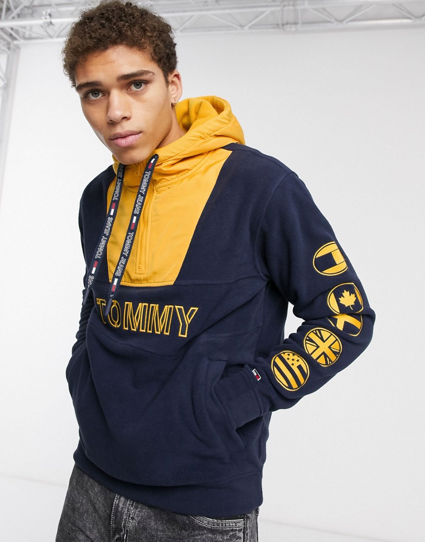 Tommy Jeans front & sleeve logo half zip hoodie in navy/yellow