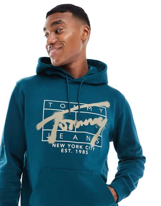 Tommy Jeans – Kapuzenpullover in Grünblau mit Graffiti-Signaturlogo