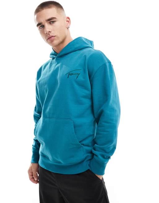Tommy Jeans – Locker geschnittener Kapuzenpullover in Blaugrün mit Signatur-Logo