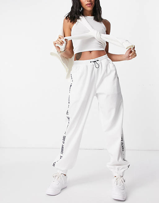Tommy Jeans logo tape trackies in white | ASOS