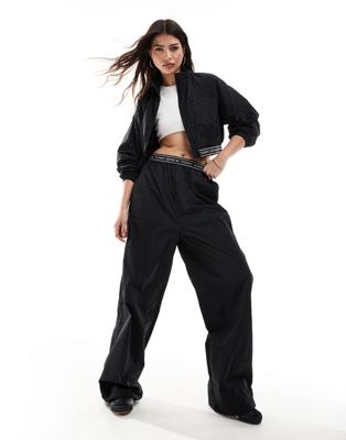 Tommy Jeans baggy taping trackpants in black - ASOS Price Checker