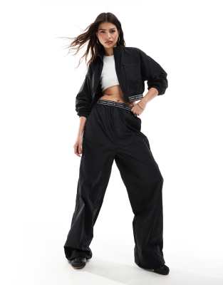 Tommy Jeans baggy taping trackpants in black - ASOS Price Checker