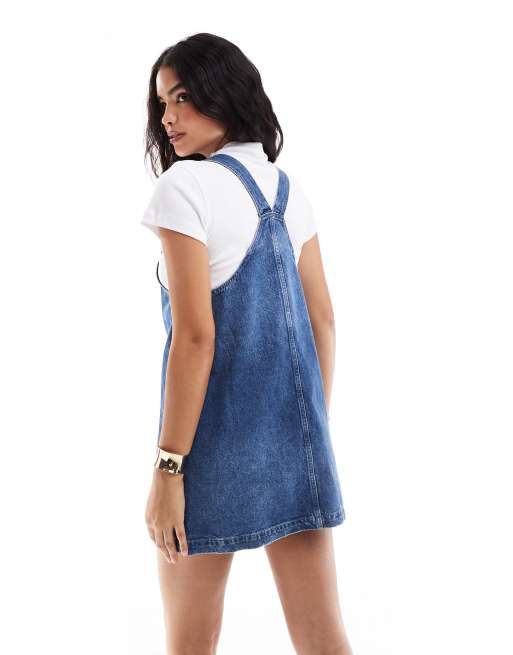 Tommy Jeans retro flag denim dungaree dress in mid wash | ASOS
