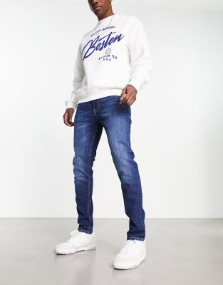 TOMMY JEANS SIMON SKINNY JEANS IN DARK WASH BLUE