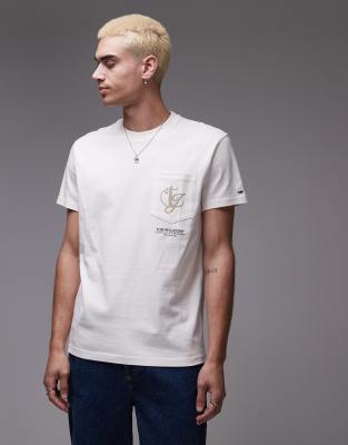 Tommy Jeans - T-shirt color bianco sporco con tasca e stampa astratta del logo sul retro
