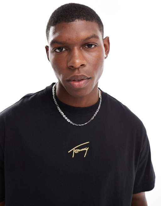 Tommy Jeans – T-Shirt in Schwarz mit mittigem, goldenem Logo
