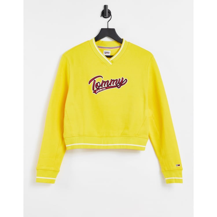 Tommy Jeans V neck Tommy logo cropped varsity sweater in yellow ASOS