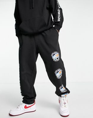 Tommy Jeans world peace print joggers in black