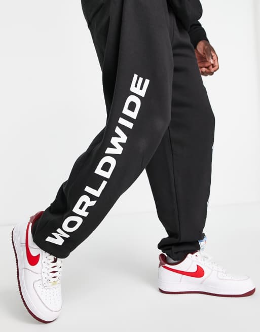 Tommy Jeans world peace print joggers in black