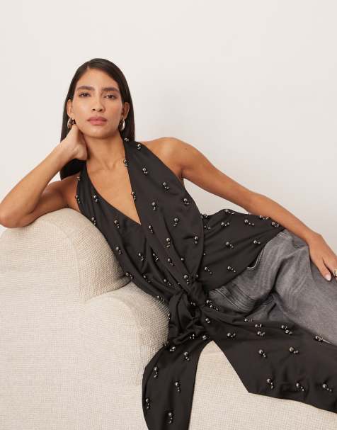 Top negro escotado con cuello halter, lazada y abalorios de ARRANGE - view 1