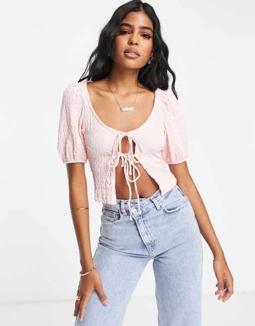 Top rosa con mangas abullonadas y lazada en la parte delantera de Monki