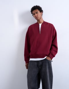 Model wearing 1/4 zip bomber in burgundy