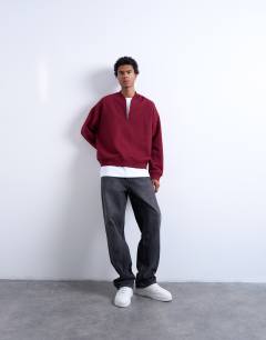 Model wearing 1/4 zip bomber in burgundy
