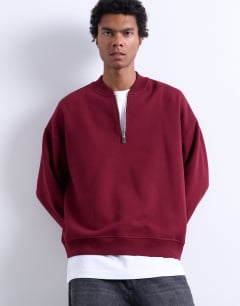 Model wearing 1/4 zip bomber in burgundy