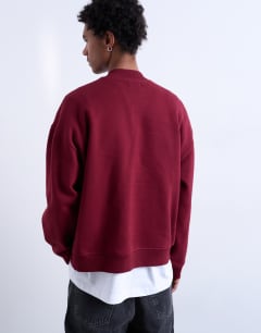 Model wearing 1/4 zip bomber in burgundy