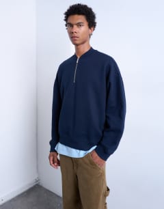 Model wearing 1/4 zip bomber in navy
