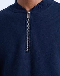 Model wearing 1/4 zip bomber in navy