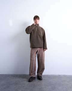 Model wearing 1/4 zip borg sweatshirt in  dark brown