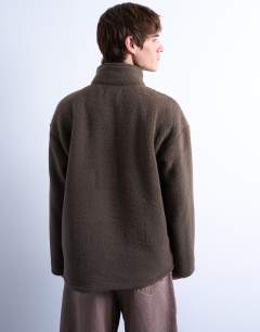 Model wearing 1/4 zip borg sweatshirt in  dark brown