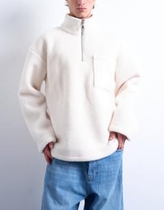 Model wearing 1/4 zip borg sweatshirt in ecru