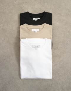 Model wearing 3 pack classic fit t-shirt in black, white and stone