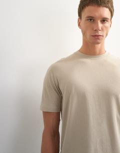 Model wearing 3 pack classic fit t-shirt in black, white and stone
