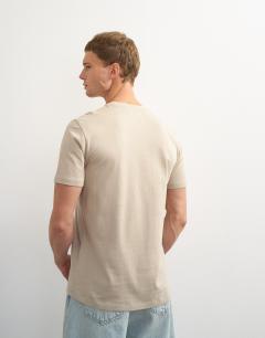 Model wearing 3 pack classic fit t-shirt in black, white and stone