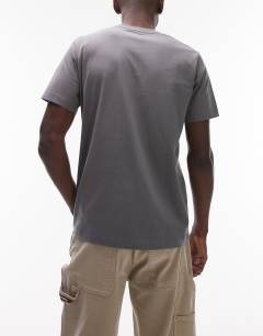 Model wearing 3 pack classic fit t-shirt in ecru, charcoal and black