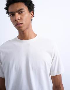 Model wearing 3 pack classic t-shirt in black, brown and ecru 