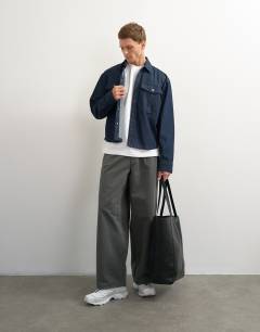 Model wearing 3 pack relaxed fit t-shirt in black, white and stone