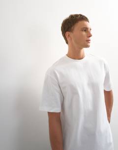 Model wearing 3 pack relaxed fit t-shirt in black, white and stone