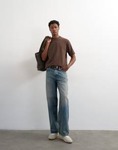 Model wearing 3 pack relaxed fit t-shirt in brown, stone and blue 