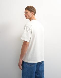 Model wearing 3 pack relaxed fit t-shirt in ecru, navy and stone