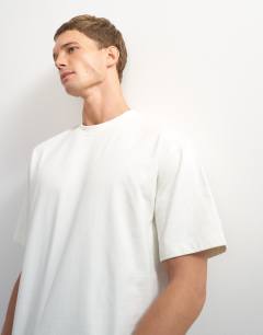 Model wearing 3 pack relaxed fit t-shirt in ecru, navy and stone