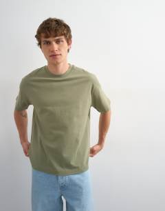 Model wearing 3 pack relaxed fit t-shirt in white, black and olive