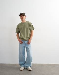 Model wearing 3 pack relaxed fit t-shirt in white, black and olive