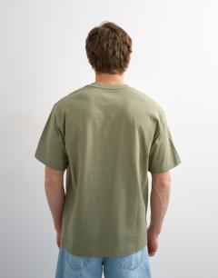 Model wearing 3 pack relaxed fit t-shirt in white, black and olive