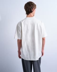 Model wearing 3 pack relaxed t-shirt in ecru, navy and burgundy