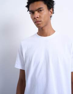 Model wearing 5 pack classic fit t-shirt in black, white, ecru, dark brown and charcoal