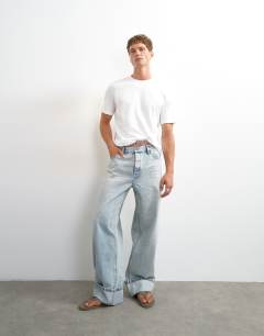Model wearing 5 pack classic fit t-shirt in black, white, khaki, navy and stone