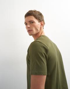 Model wearing 5 pack classic fit t-shirt in black, white, stone, navy and khaki