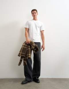 Model wearing 5 pack classic fit t-shirt in white, black and stone