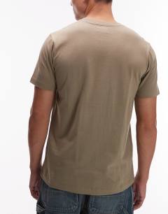 Model wearing 5 pack classic fit t-shirt in white, ecru, khaki, charcoal and black