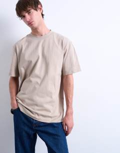 Model wearing 5 pack relaxed fit t-shirt in black, white, beige, sage and charcoal 